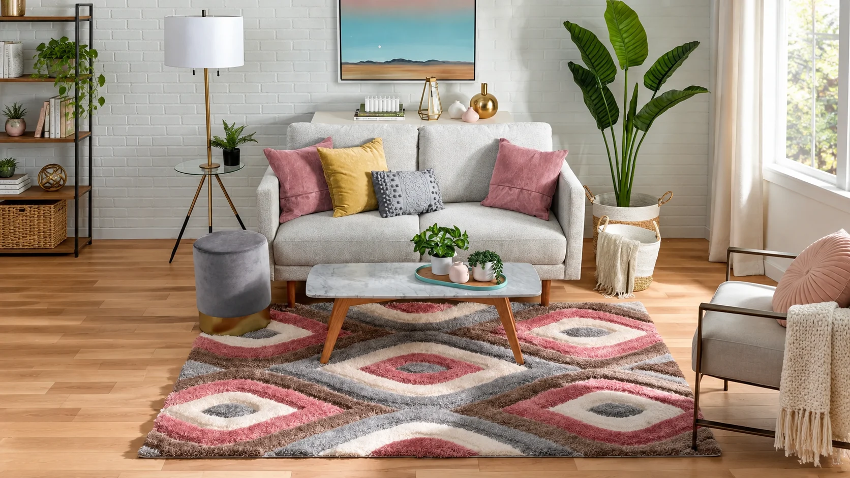 Pink, grey and cream wave-patterned rug beneath a marble coffee table in a bright living room